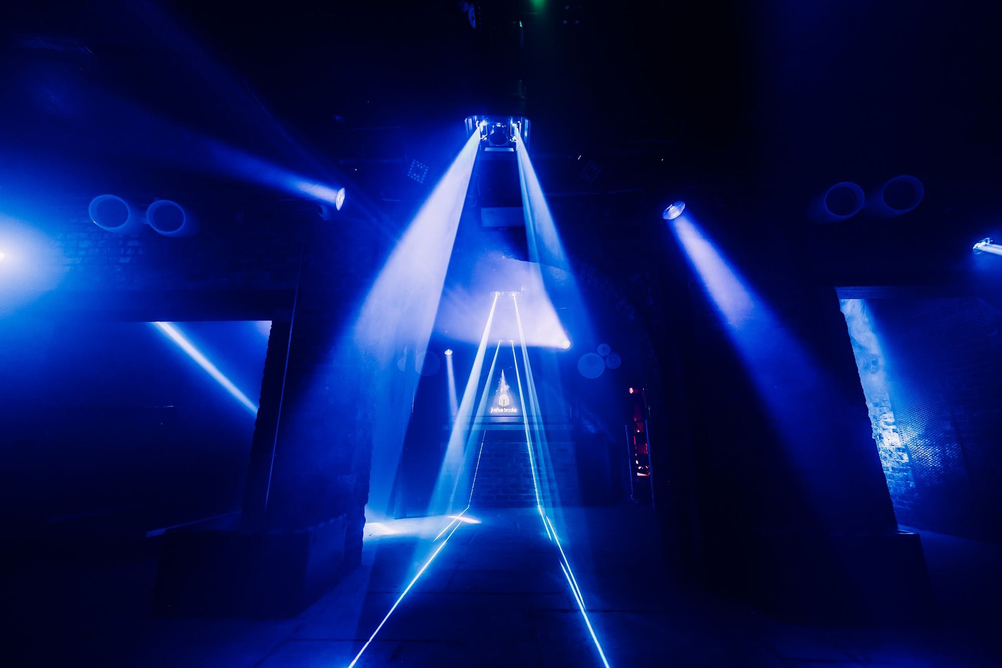 blue light beams over the dance floor
