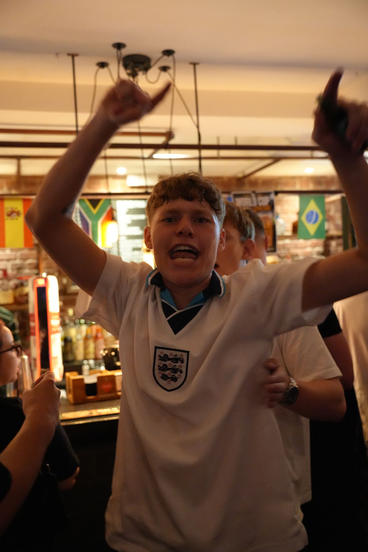 an England fan celebrating in the bar at JB's