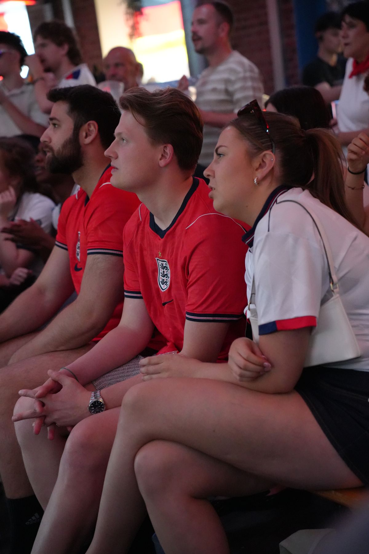 fans in England shirts watching the match